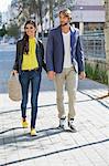 Happy couple walking on a street