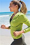 Smiling woman running on the beach