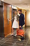 Couple standing outside an elevator at an airport