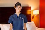 Portrait of a maid smiling in a hotel room