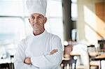 Chef standing with arms crossed in a restaurant