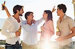 Four friends enjoying beer in party