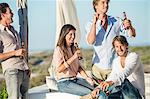 Group of friends enjoying beer outdoors on vacation