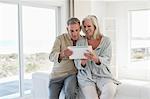 Smiling senior couple using a digital tablet