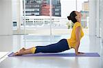 Woman exercising on exercise mat in a gym