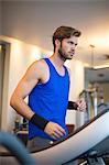 Man running on a treadmill in a gym