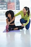 Woman exercising with her instructor in a gym