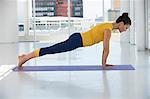 Woman exercising on exercise mat in a gym