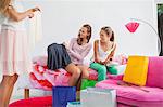 Girl showing skirt to her friends at a slumber party