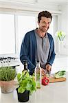 Man chopping vegetables in a kitchen