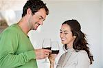 Couple toasting with wine glasses and smiling