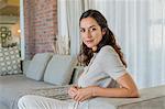 Portrait of a beautiful woman sitting on a couch