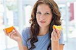 Portrait of a woman holding an orange