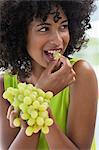 Close-up of a woman eating grapes