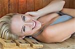 Portrait of a smiling woman relaxing in a sauna