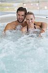 Portrait of a smiling couple in a hot tub