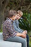 Two teenage boys sitting together and discussing