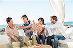 Group of friends toasting drinks outdoors on vacation