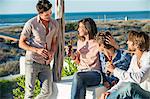 Group of friends enjoying beer outdoors on vacation