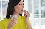 Close-up of a woman taking medicine