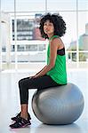 Portrait of a woman sitting on a fitness ball