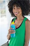 Portrait of a woman holding a water bottle and smiling