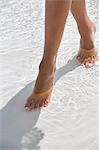 Woman walking in water on the beach