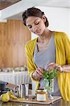 Woman preparing herbal tea in the kitchen