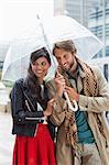 Smiling couple under umbrella