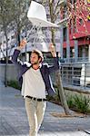 Man walking on a street with a chair