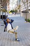 Man relaxing on a chair on a street