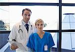Doctor and nurse standing by window