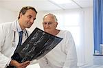 Doctor and patient examining x-rays in hospital room