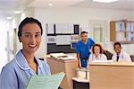 Nurse smiling in hospital hallway