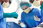 Surgeons working in operating room