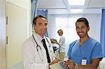 Doctor and nurse talking in hospital room