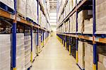 Stacks of boxes in aisle in warehouse