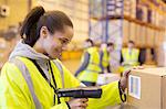 Worker scanning box in warehouse