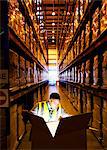 Worker opening glowing box in warehouse