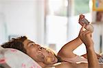 Couple using cell phone in bed