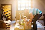 Couple unpacking boxes in attic