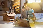 Couple unpacking boxes in attic