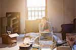 Woman unpacking boxes in attic