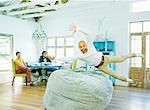 Man jumping into beanbag chair