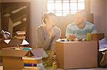 Couple eating sushi together in new home