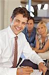 Financial advisor smiling with couple on sofa