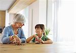 Older woman and granddaughter filling change jar