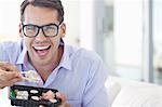 Businessman eating sushi in office