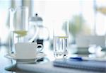 Coffee cups and water glasses on meeting table