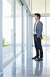 Businessman standing at office window